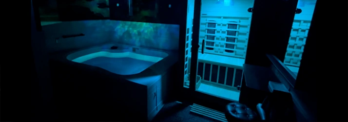 Recovery And Health Spa Doylestown PA Cold Plunge Tank Dark Room With Icy Blue Lighting Featuring A Cold Plunge Tank