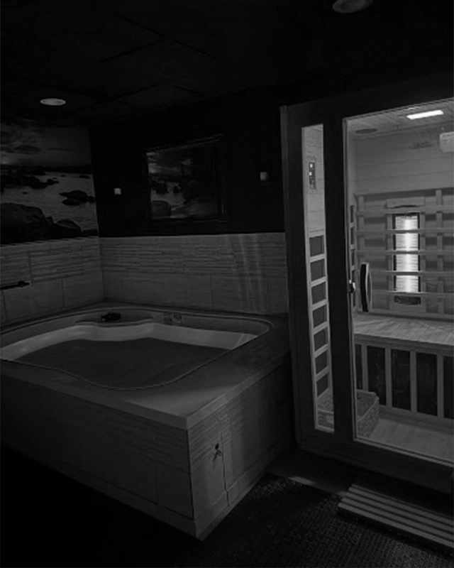 Cold Plunge Tank Next To Hot Infrared Sauna In Dark Room With A Black and White Filter